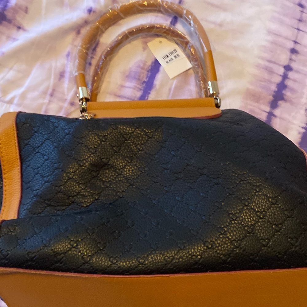 Black purse with gold edges, and red detail.